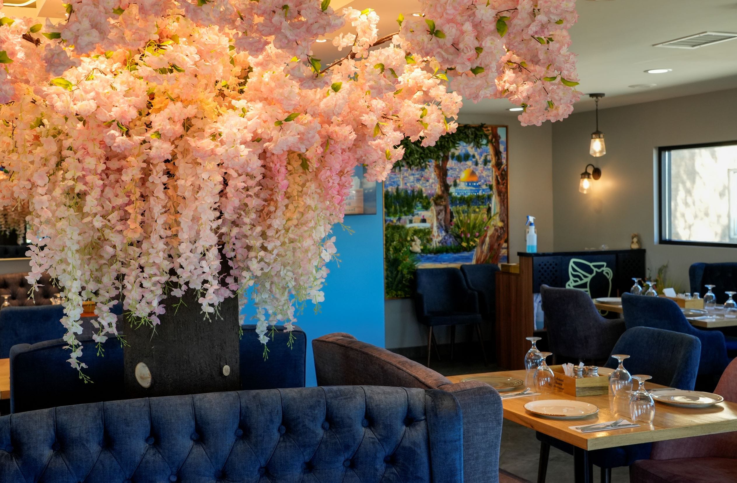 At Lebnani House in Greenfield, a silk floral display is the centerpiece of the dining room, decorated in serene blues and greens.