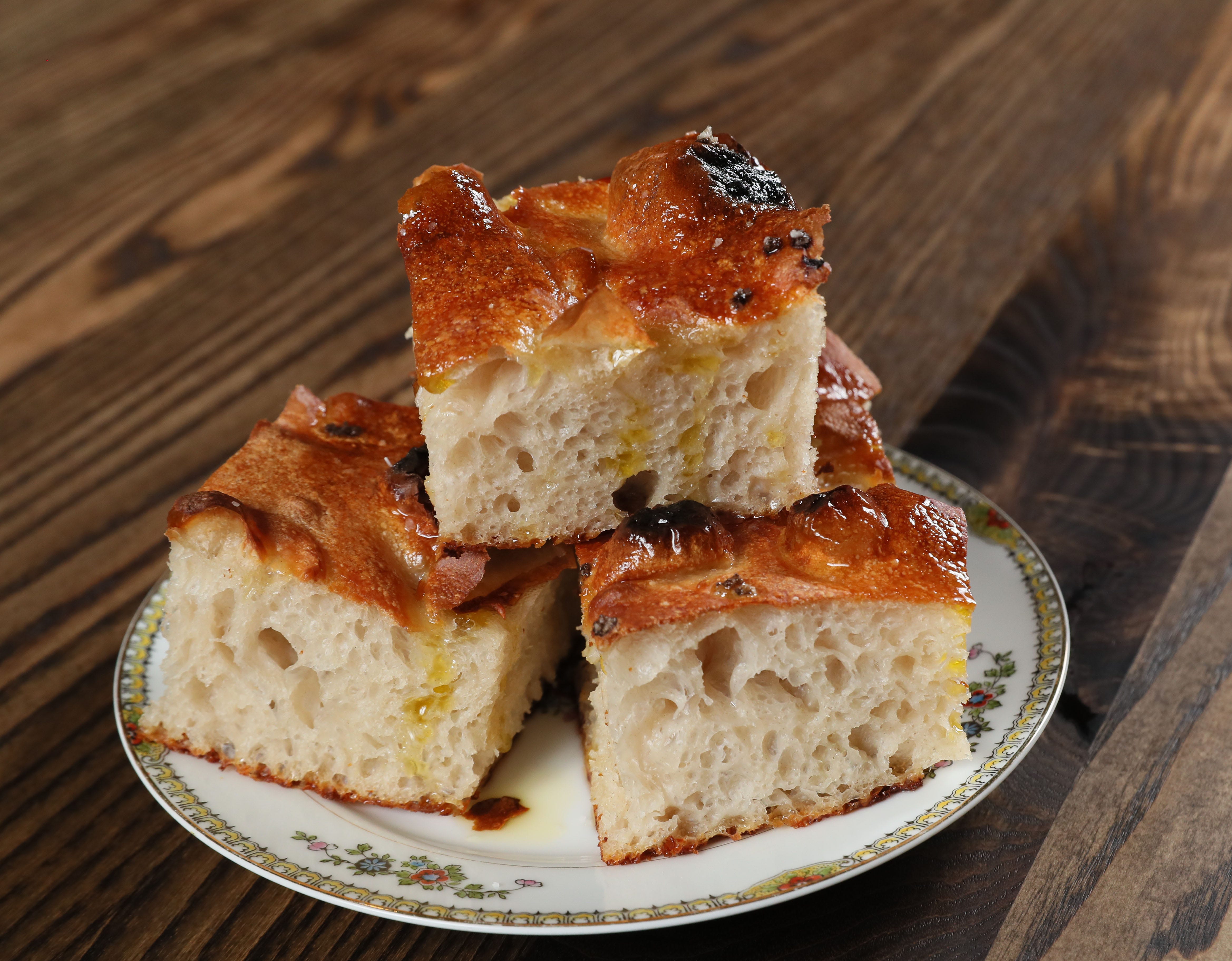 The statuesque house focaccia, drizzled with extra-virgin olive oil, is a must-have menu item at Ca’ Lucchenzo in Wauwatosa.