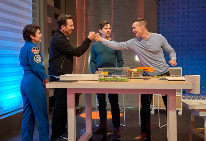 "LEGO MASTERS" contestant Greg Tull fist-bumps the show's host Will Arnett during episode one of season three. Greg's younger brother Brendon Tull, of Springfield, stands beside him. Guest judge Jessica Meir is dressed as an astronaut beside Arnett. The Tull brothers are two of 24 contestants competing on season three of "LEGO MASTERS."