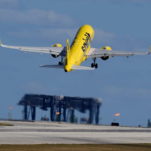 A Spirit Airlines Airbus A320 takes off from Fort 