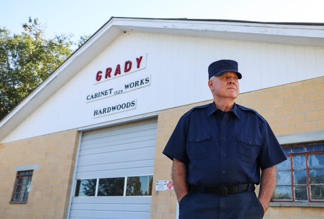 Ricky Grady, 68, poses for a portrait in front of Grady Cabinet Works in Gainesville on Oct. 7. Grady is retiring and closing the business because he had no sons to pass the business down to.