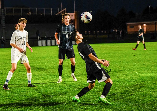 Leo Arana (8) from Okemos settles the ball against East Lansing in Gold Cup Final play Thursday, Oct. 6, 2022.