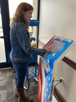 Andrea Smyth, a clerk in the Reno County Treasurer's Office, demonstates how to access information about different county departments on a new kiosk inside the front door of the County Annex. County Administator Randy Partington came up with the idea for the equipment so people getting vehicle tags could see what documents they needed before getting in line and being turned away because they didn't have all they needed.