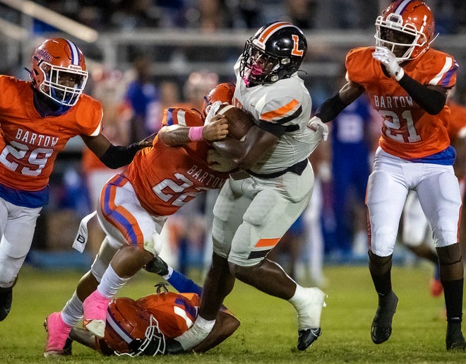 Lakeland Dreadnaughts (5) Rolijah Hardy is tackled by Bartow defenders during a kickoff return during first-half action at Bartow High School in Bartow on Oct. 6.