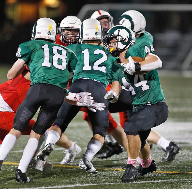 His teammates try to open a hole in the line for Marshfield's Aidan True.  True scored twice and rushed for more than 100 yards on Friday night in a 35-14 victory over Hingham.