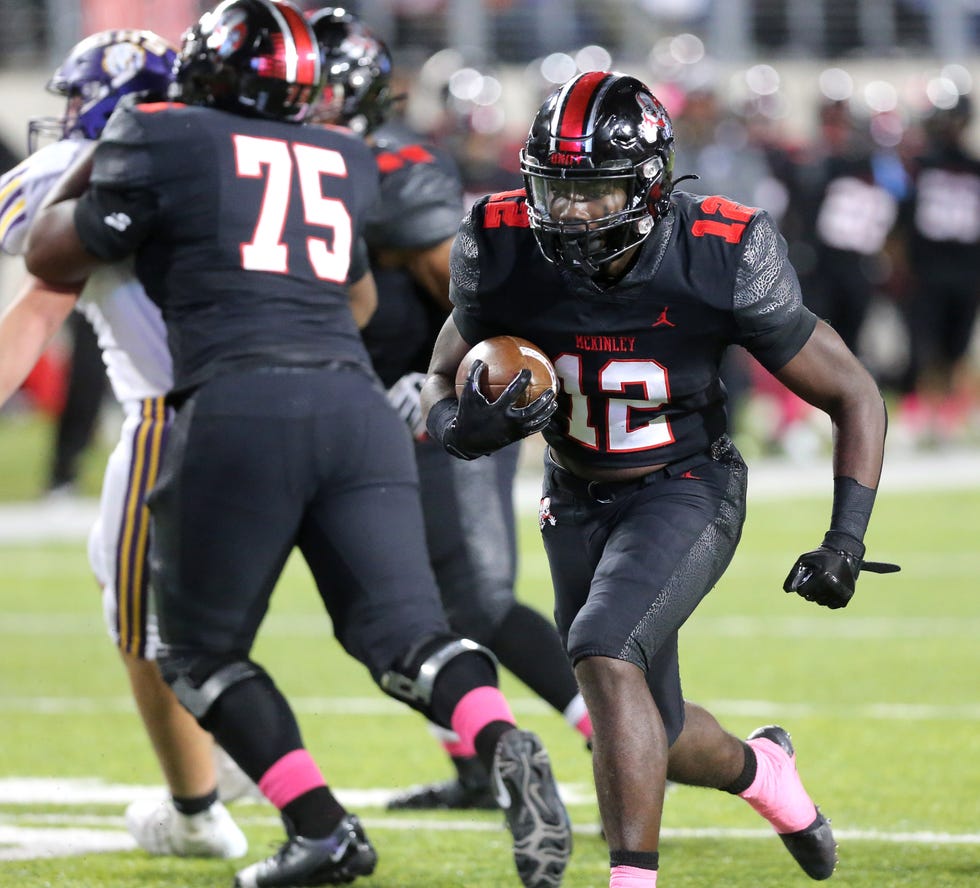 Nino Hill of McKinley runs for a touchdown behind the block of Kaelub Edwards, 75, during their game against Jackson at McKinley on Friday, Oct. 7, 2022.
