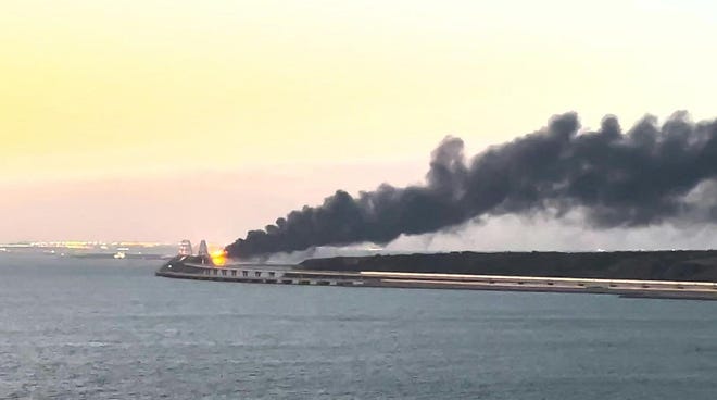 This video grab taken and released on Saturday, Oct. 8, 2022 shows thick black smoke rising from a fire on the Kerch Bridge that links Crimea to Russia.