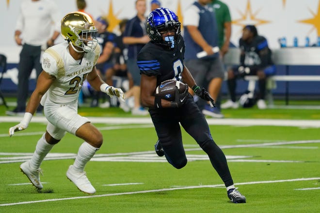 Oct 8, 2022; Paradise, Nevada, USA; Brigham Young Cougars wide receiver Kody Epps (0) runs with the ball against Notre Dame Fighting Irish corner back Jaden Mickey (21) during the second half at Allegiant Stadium. Mandatory Credit: Lucas Peltier-USA TODAY Sports
