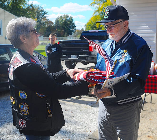 Kenneth Harper, right, receives a Quilt of Honor from Melissa Seibert on Saturday, Oct. 8, 2022, during a ceremony at Harper's Lexington Township home. Harper was honored for his many years of service in the U.S. Navy, Army Reserves and Army National Guard.