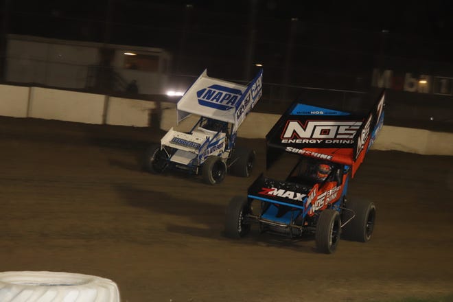 Tyler Courtney, front, battles Cap Henry for the win on the first night of the Jim and Joanne Ford Classic.