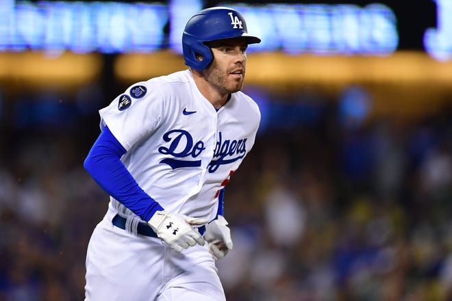 Oct 1, 2022; Los Angeles, California, USA; Los Angeles Dodgers first baseman Freddie Freeman (5) runs after hitting a single against the Colorado Rockies during the eighth inning at Dodger Stadium.