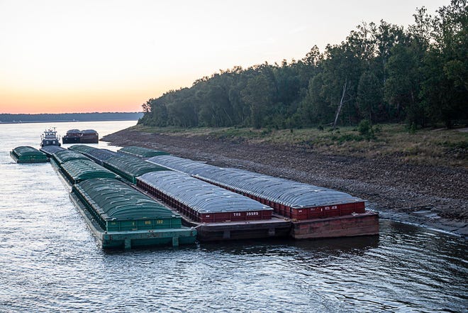 Barges idle while waiting for passage in the Mississippi River near Vicksburg, Miss., on Tuesday, Oct. 4, 2022.