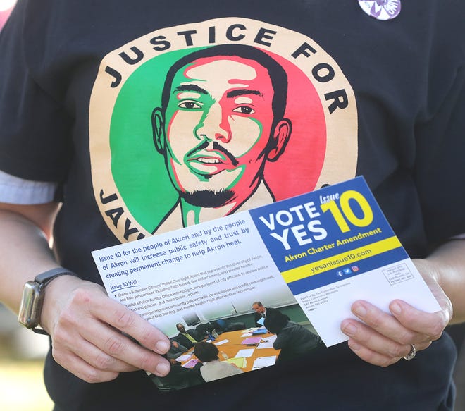 Activists distributed Issue 10 literature before a call for justice for Jayland Walker at Grace Park on Monday, Oct. 10, 2022, in Akron.