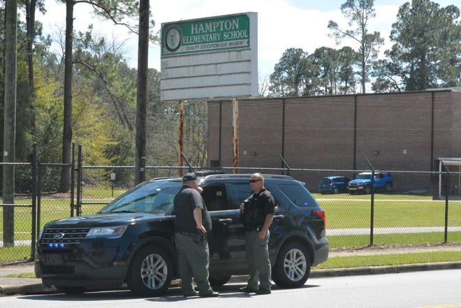 File Photo: Hampton County police officers stand watch outside Hampton Elementary School during a recent bomb threat.