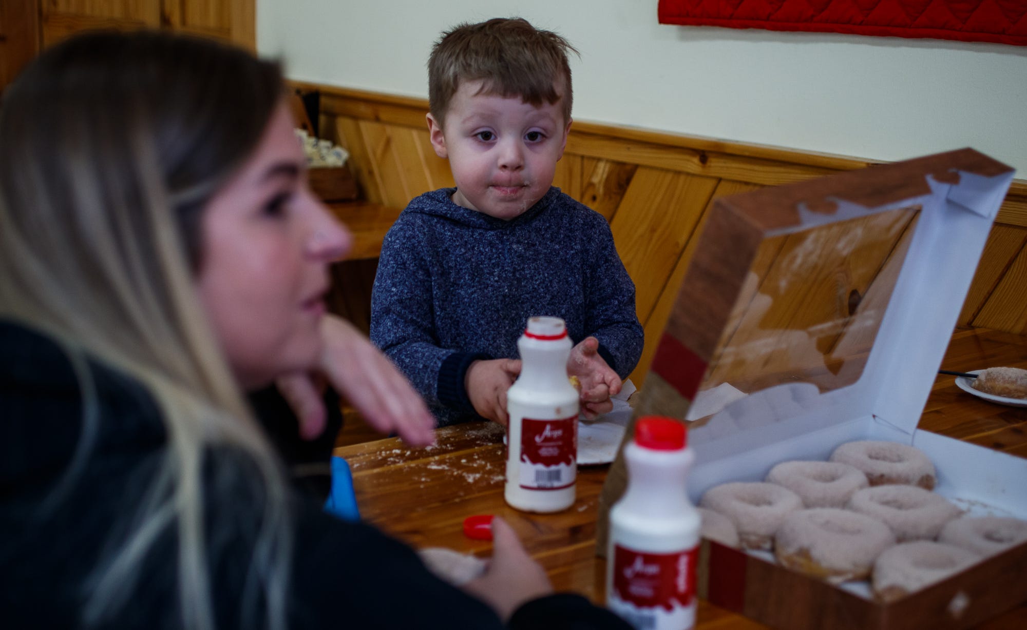 Harvey, 3, eats a donut at Rise'n Roll Bakery in Middlebury, Indiana, alongside his mother, Abey Bonifield, after dropping off his older brother, Connor, 13, at school. "I wanted our time to be more quality time than me just being there, zombified on the couch," she said. "Some days you're falling asleep before it's bedtime for them. It's just exhausting, you feel kind of delirious all the time, like your day is never quite right."