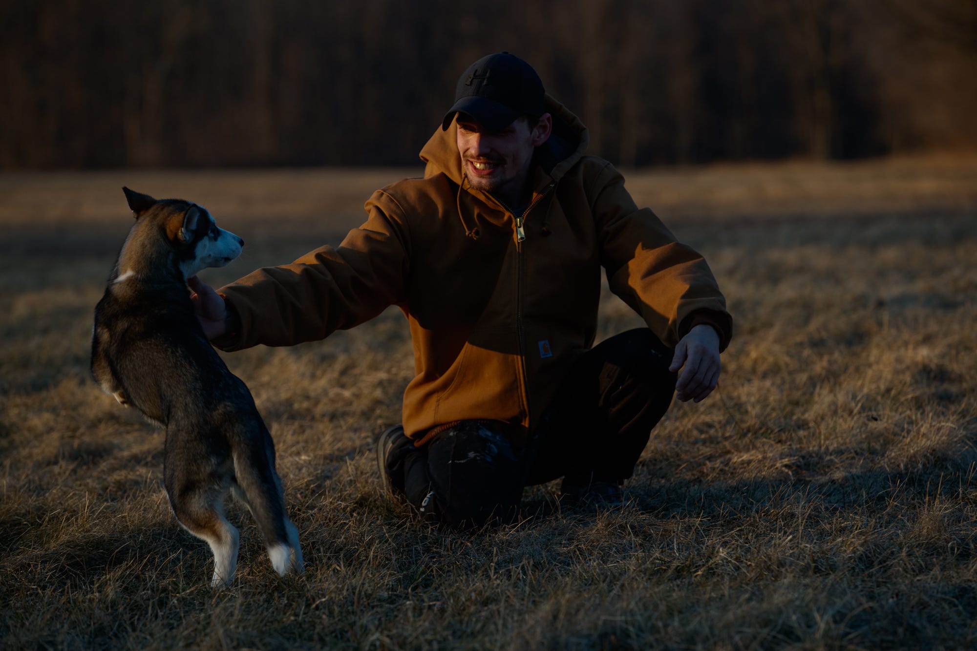 Tanner McAfee plays with his puppy Meekah earlier this year in a field near his home just over the Indiana border in Michigan. He worked in the RV industry for 10 years, saving to buy a home and have land. "She is absolutely therapeutic," McAfee said. "When I have a dog so excited when I come home, there's no better joy in the world. Her being happy makes me happy."