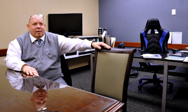 Boys and Girls Club of Wooster Executive Director Jon Hutchison sits at the conference table in his office at 124 North Walnut St. The nonprofit relocated last month, following months of planning and continued growth.