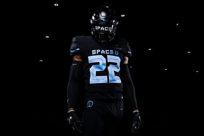 Emphasizing the vast void of deep space, UCF's 2022 Space Game Black uniform is offset by Canaveral Blue "The space of U" letters and numbers indicating the mode of transit to detect the exoplanet.
