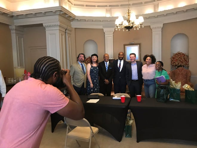 Members of Shelby County Mayor Lee Harris' 'next era' committee pose for a photo with Harris after a planning meeting on Friday, Sept. 23, 2022.