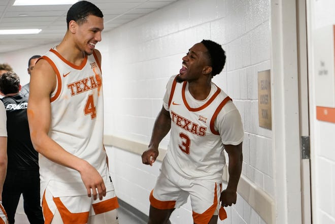 Texas forward Dylan Disu, left, and guard Courtney Ramey celebrate an upset win over Kansas in February on the way back to the locker room at the Erwin Center. It was Disu's first season at Texas after transferring from Vanderbilt.