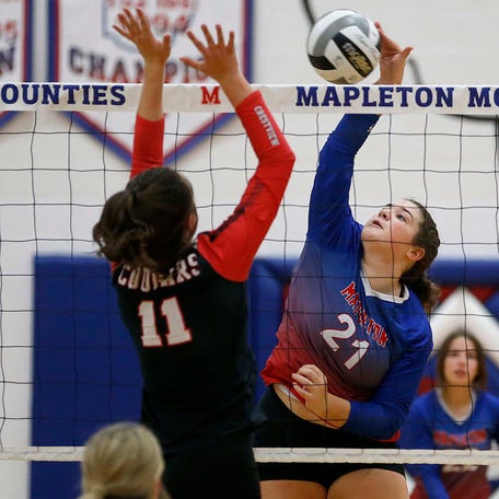 Mapleton High School's Bre McKean (21) plays a ball at the net against Crestview High School's Emily Weaver (11) during high school volleyball action at Mapleton High School Tuesday, Oct. 11, 2022. TOM E. PUSKAR/ASHLAND TIMES-GAZETTE
