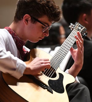 Oct 11, 2022; Tuscaloosa, AL, USA; Ukranian exchange student Tymofii Polkovnichenko plays a guitar solo during the Fall Concert presented by the Northridge High School Fine Arts department at Moody Music Hall Tuesday, Oct. 11.