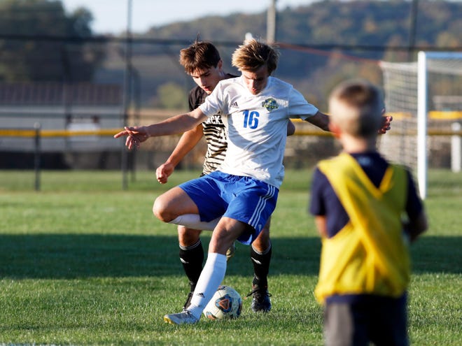 River View's Laired Williamson, left, and West Muskingum's Steven Crumbaker fight for the ball during their match on Tuesday in Warsaw. The Black Bears won, 14-0.