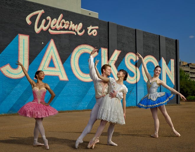 Dancers from the USA International Ballet Competition pose in front of the iconic “Welcome to Jackson” mural at State Street and Pearl Street downtown.