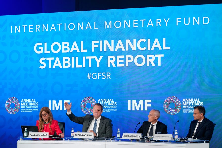Tobias Adrian, second from left, monetary and capital markets department director at the International Monetary Fund, speaks at a news conference on the IMF's Global Financial Stability Report during the 2022 annual meeting of the IMF and the World Bank Group, Tuesday, Oct. 11, 2022, in Washington.
