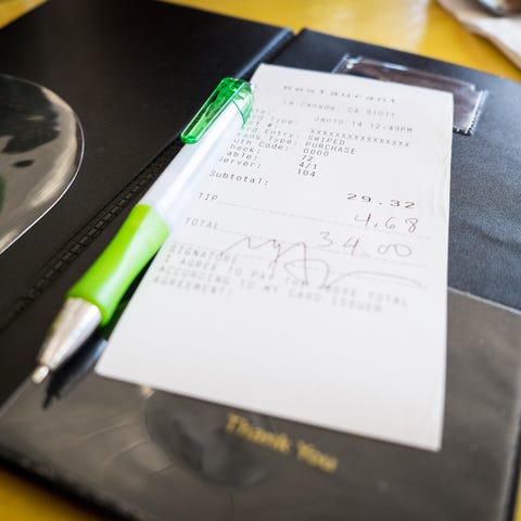 Credit card bill and pen in a restaurant.