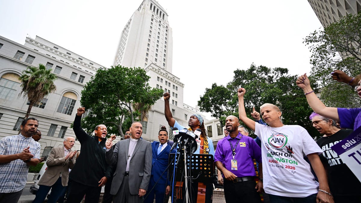 Faith, labor, immigrant and community members rally outside City Hall to denounce racism and demand change on October 11, 2022 in Los Angeles, California, in response to a recorded, racially charged leaked conversation between leaders at City Hall and the Los Angeles County Federation of Labor President.