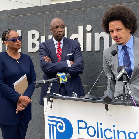 Comedian Eric André, right, speaks at a news confe