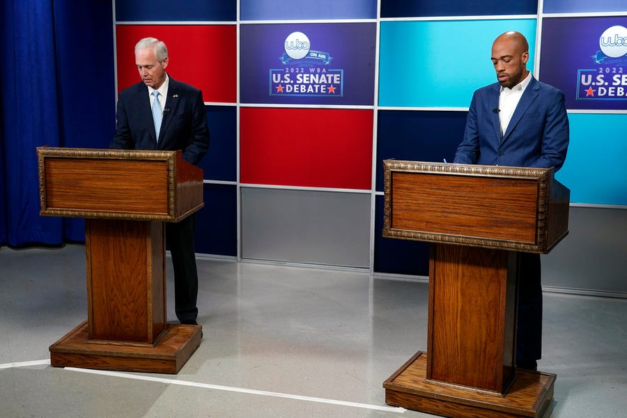 U.S. Sen. Ron Johnson, R-Wis., left, and his Democratic challenger Mandela Barnes take notes before a televised debate, Friday, Oct. 7, 2022, in Milwaukee.
