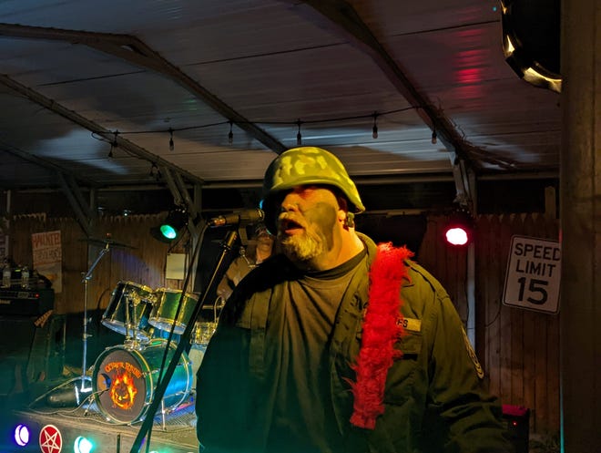 Doug Ramsey, a member of October Rising, performs with the band at Akron's Haunted Schoolhouse and Haunted Laboratory.