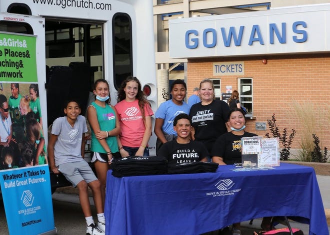 Boys and Girls Clubs of Hutchinson members pose near a van outside of Gowans Stadium that was packed with food at the 2021 Hutchinson High School Salt Hawk Football Food Drive. The 2022 food drive is scheduled for the Salt Hawks’ home game against Andover Oct. 21.