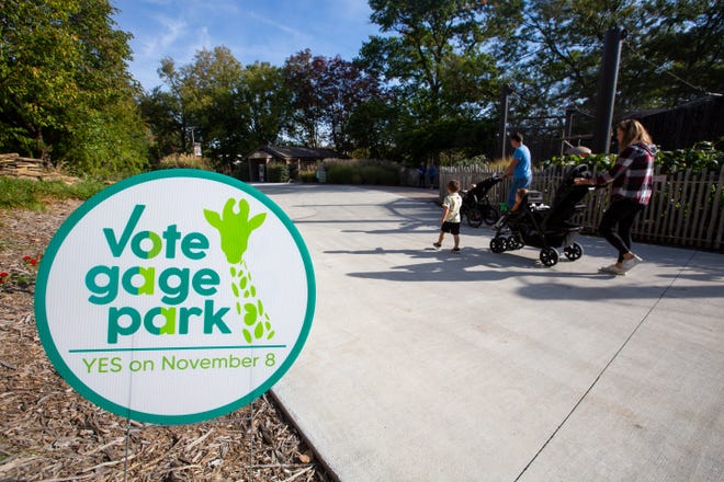A "Vote Gage Park" sign is displayed at the Topeka Zoo while visitors pass by exhibits last month. Voters passed the measure by a wide margin.