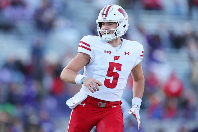 EVANSTON, ILLINOIS - OCTOBER 08: Graham Mertz #5 of the Wisconsin Badgers celebrates a touchdown against the Northwestern Wildcats during the second half at Ryan Field on October 08, 2022 in Evanston, Illinois. (Photo by Michael Reaves/Getty Images)