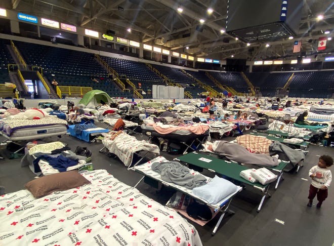 Hundreds of people usingÊthe Hertz Arena in Estero, Fla., as shelter are sleeping in the Florida Everblades hockey rink on Thursday, Oct. 13, 2022.