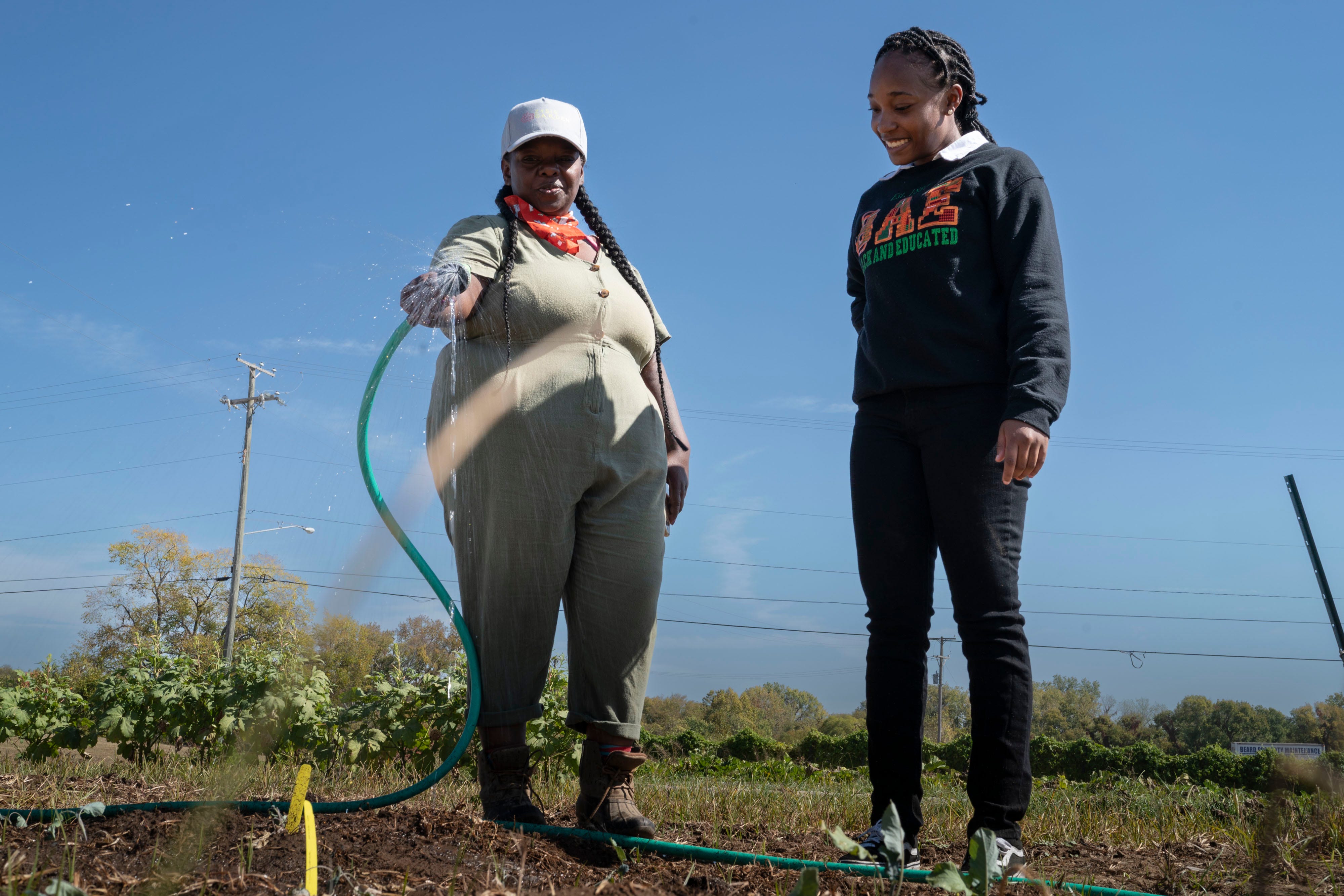 Tennessean opinion and engagement writer Kyra Watts, right, visits with Bridget Bryant of Zysis Garden on the Tennessee State University campus in Nashville.