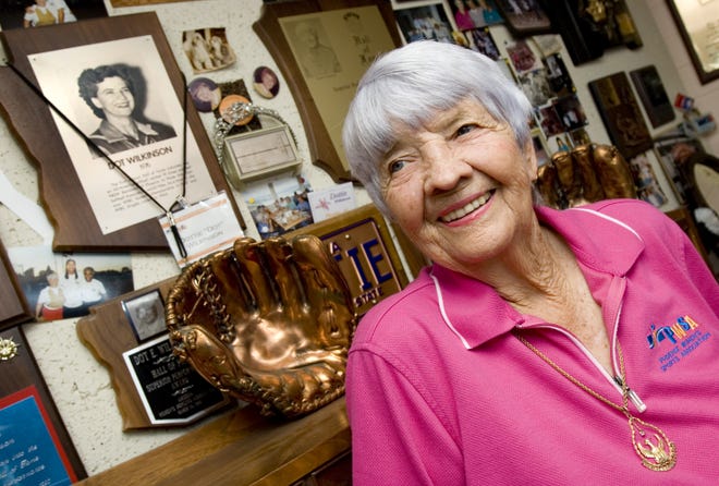 Dot Wilkinson poses at her Phoenix home in this file photo dated June 18, 2007, with some of the souvenirs from her many years playing softball with the Phoenix Ramblers.