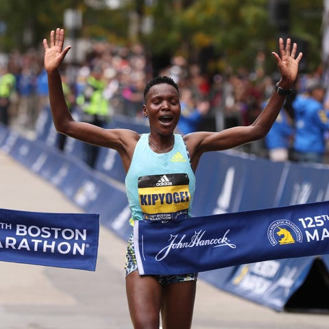 Diana Kipyogei of Kenya crosses the finish line to