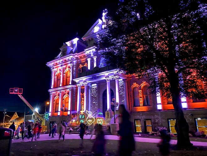 The Guernsey County Courthouse is lit up for the annual Halloween Light Show. Kids and families enjoy the show from the lawn, playing and listening to the program which features Halloween hits like "Purple People Eater," "Thriller," and pieces from "The Nightmare Before Christmas."
