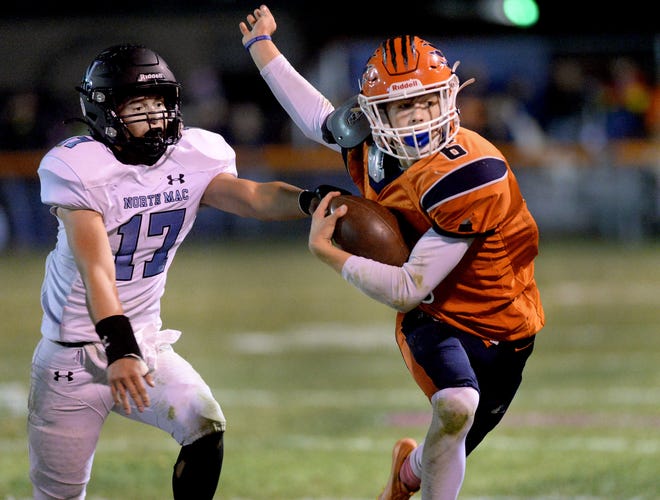 Pana's Max Lynch, right, runs around North Mac's Kaden Brown during the game Friday Oct.14, 2022.