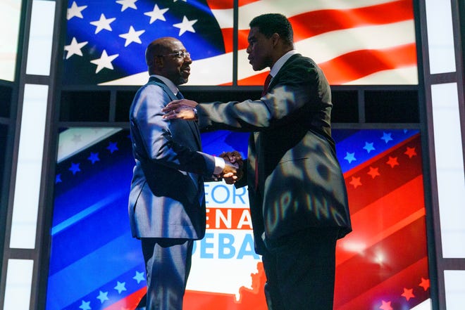 Sen. Raphael Warnock, D-Ga., shakes hands with Republican candidate Herschel Walker prior to the Nexstar Georgia Senate Debate in Savannah, Ga., on Oct. 14, 2022.