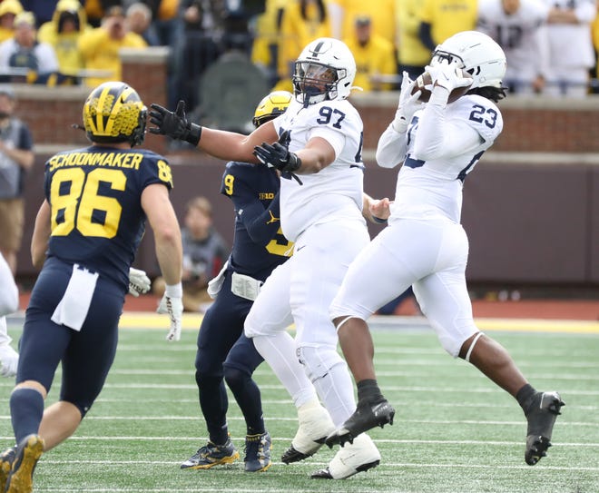 Penn State linebacker Curtis Jacobs (23) intercepts a deflected pass from Michigan quarterback JJ McCarthy (9) in the first half of October.  January 15, 2022 at Michigan Stadium in Ann Arbor.