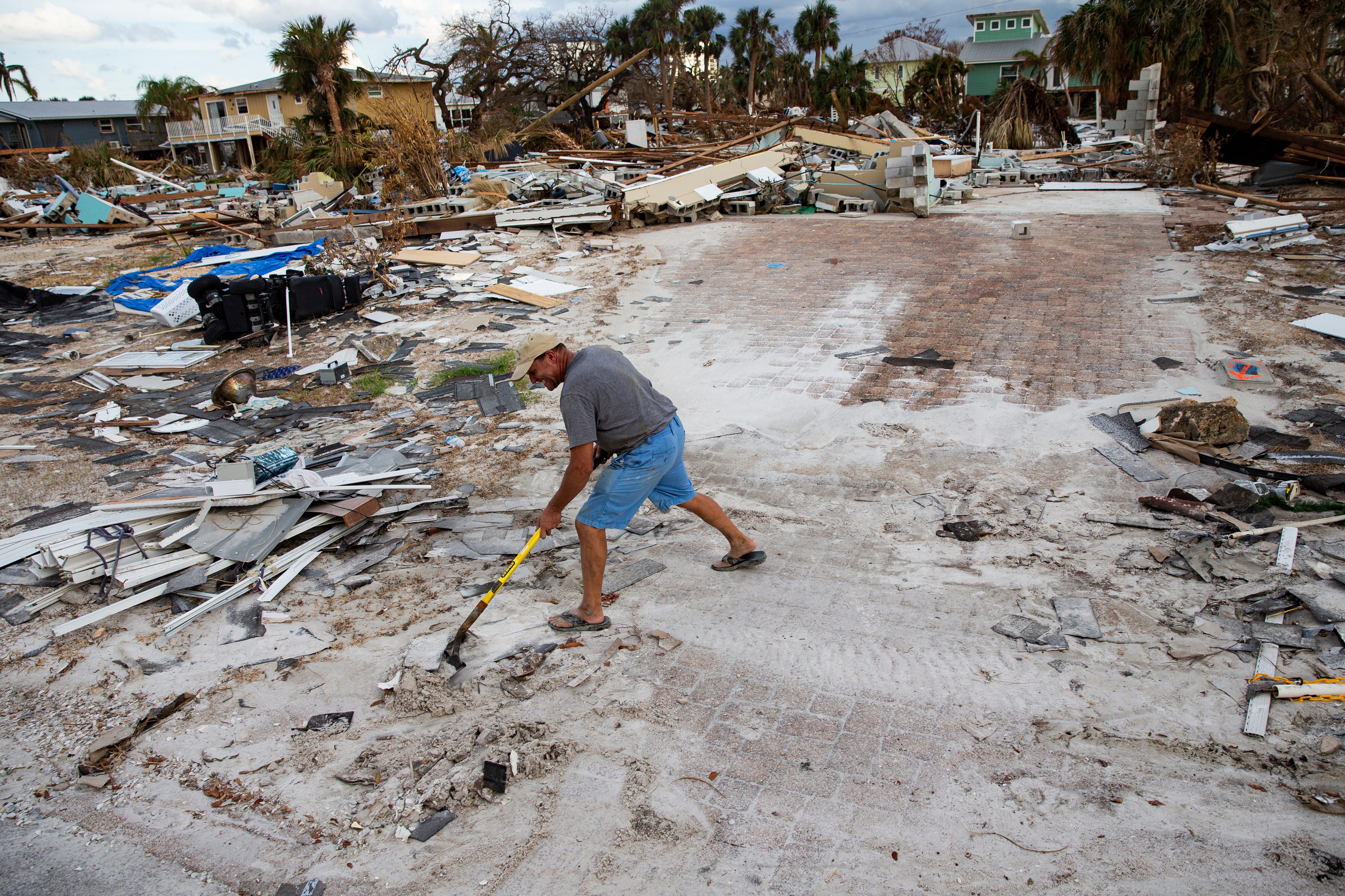 Tim Szekely cleans up at his Fort Myers Beach home on Hibiscus Drive. The neighborhood was heavily impacted by Hurricane Ian. Many homes were destroyed and all of them sustained major flooding. The part-time resident is planning to rebuild.