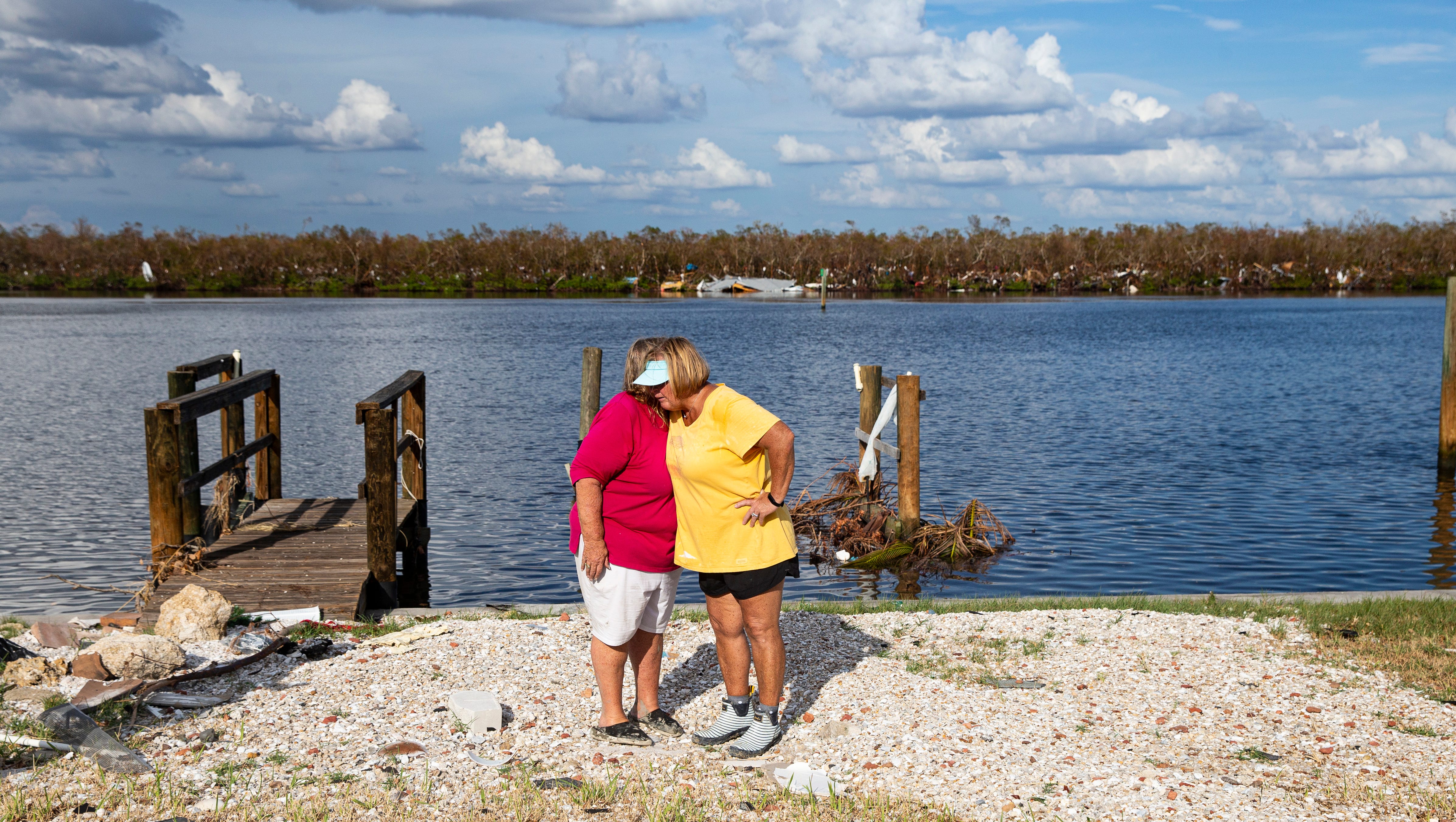 Judi Woods, a resident of Hibiscus Drive on Fort Myers Beach, hugs neighbor Debbie Lemmer after seeing damage to her home for the first time on Oct. 11, 2022. The neighborhood was heavily impacted by Hurricane Ian. Many homes were destroyed and all of them sustained major flooding.