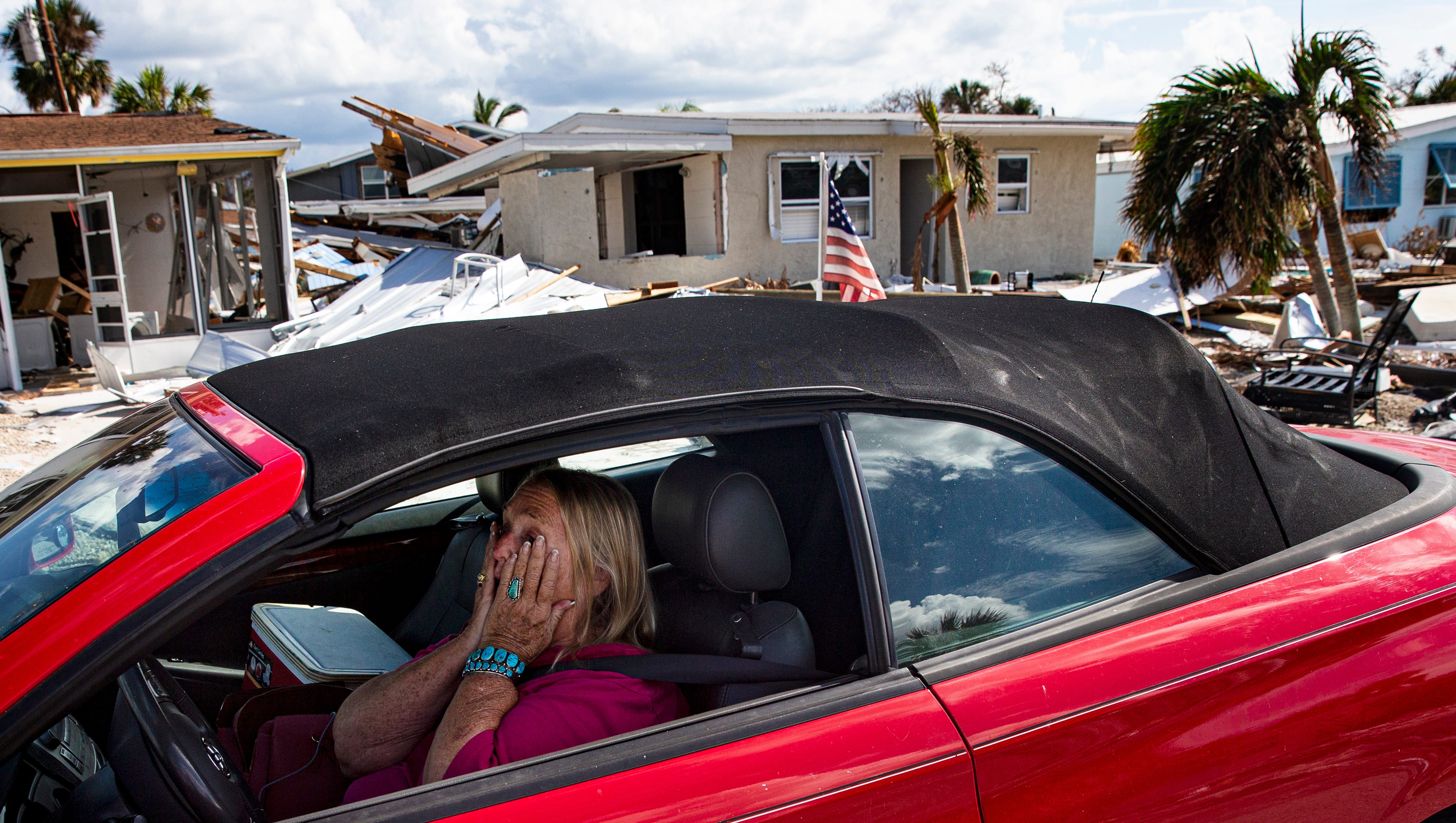 Seeing her neighborhood for the first time since Ian hit, Judi Woods, a resident of Hibiscus Drive on Fort Myers Beach, brings her hands to her face, reacting as she approaches her home on Oct. 11, 2022. Her neighborhood and home were heavily impacted by Hurricane Ian. Her home sustained significant damage.