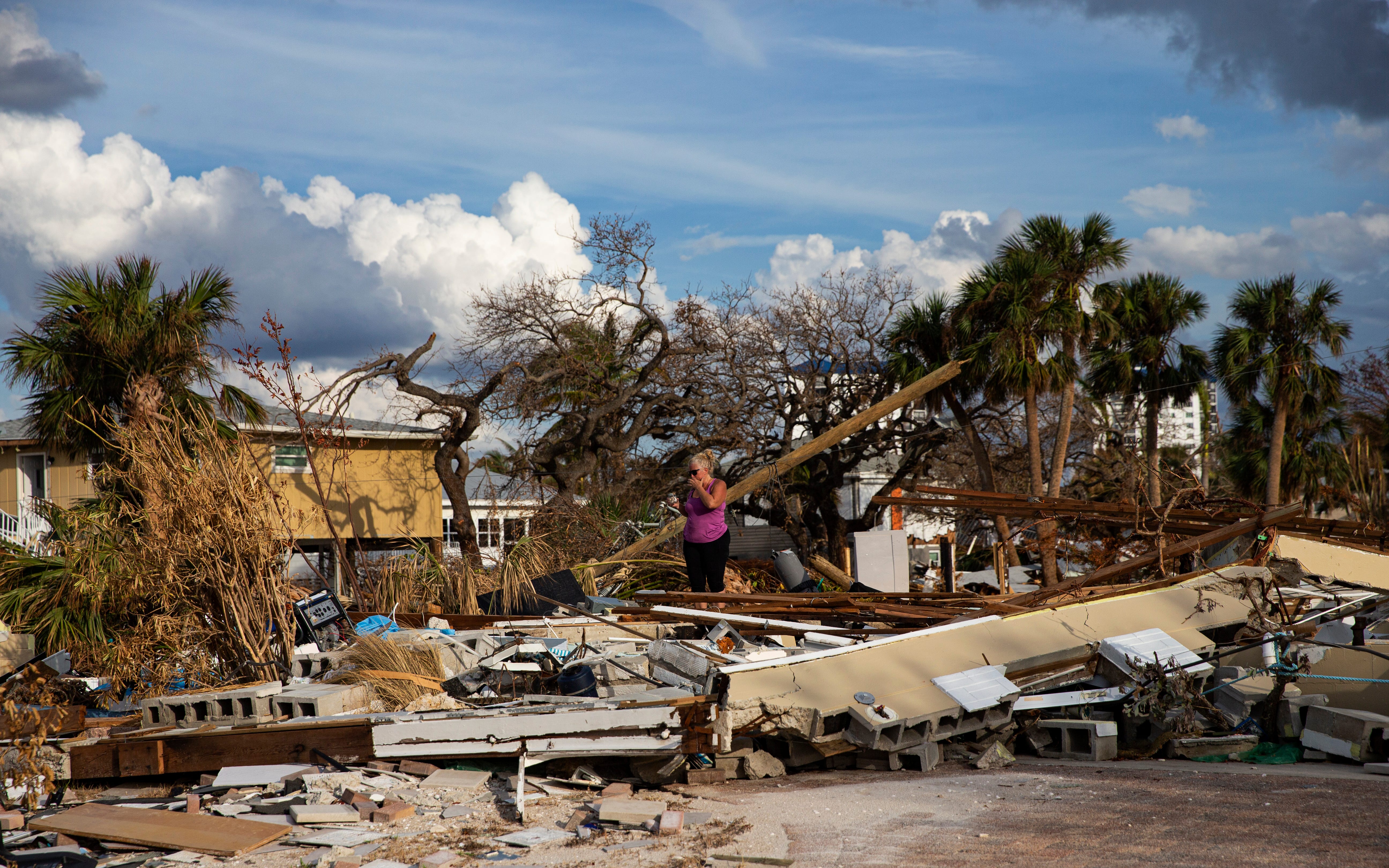 Debbi Szekely searches through what remains of her home on Hibiscus Drive on Fort Myers Beach. The neighborhood was heavily impacted by Hurricane Ian. Many homes were destroyed and all of them sustained major flooding. She and her husband Tim were cleaning up and looking through the wreckage. The part-time residents are planning to rebuild.