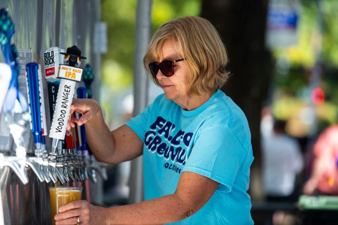 Η εθελόντρια του Fall for Greenville, Brenda VanPutten, ρίχνει μπύρα ενώ εργάζεται στο Fall for Greenville το Σάββατο 15 Οκτωβρίου 2022.